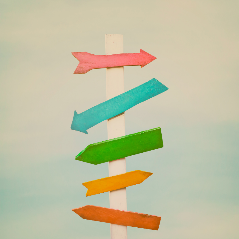 Colourful arrows on a signpost